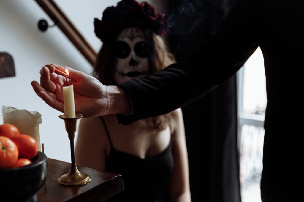 An artistic depiction of a Dia de los Muertos ritual with intricate face paint and candle lighting.